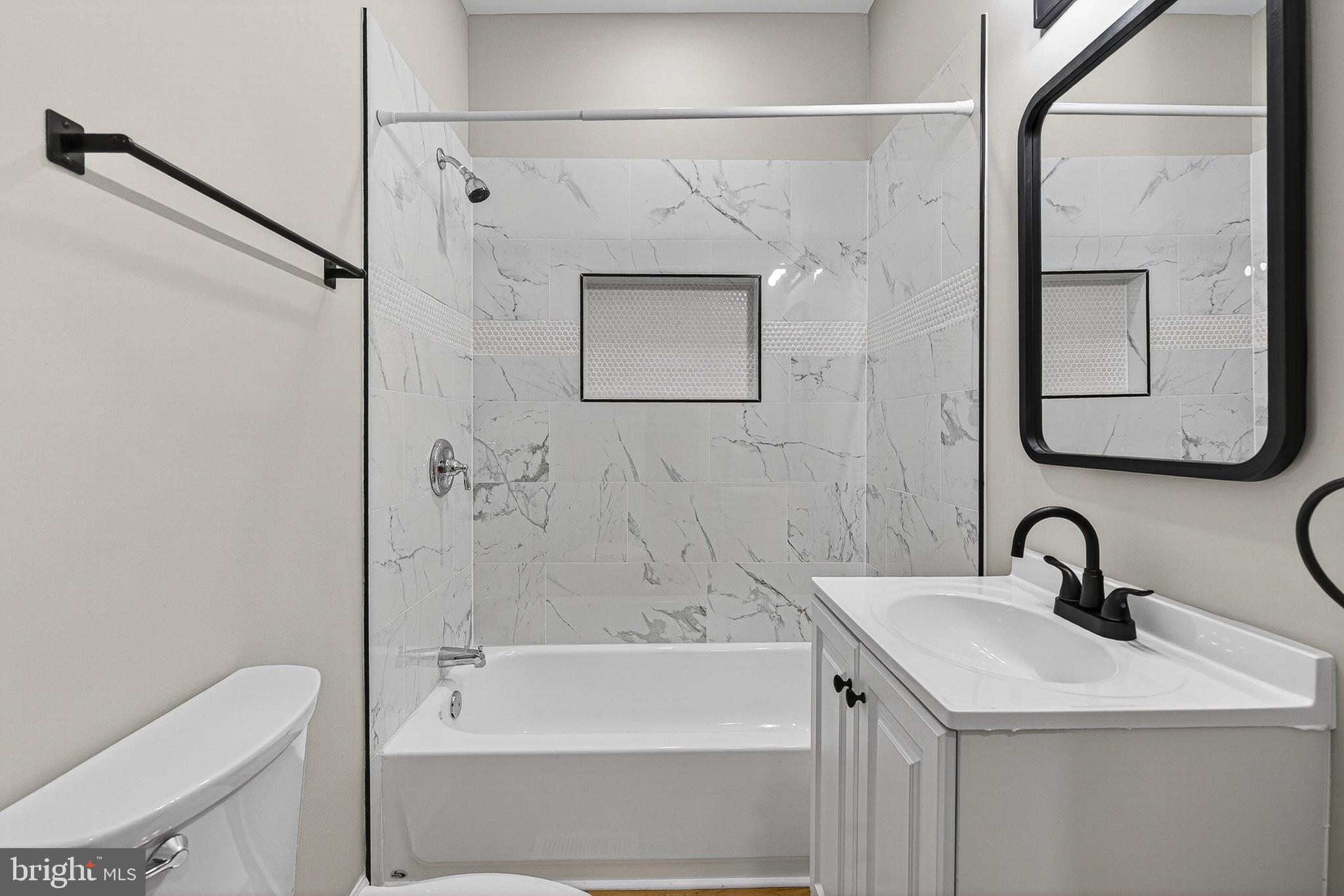 2518 West Fayette Street Baltimore, MD 21223 - Photo 13 of 32 a bathroom with a sink toilet and shower