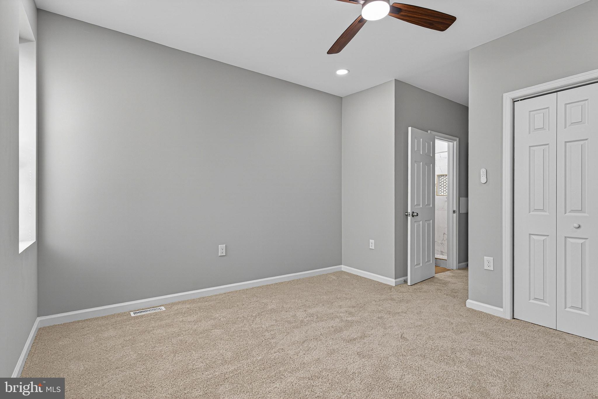 2518 West Fayette Street Baltimore, MD 21223 - Photo 21 of 32 an empty room with a ceiling fan and carpet