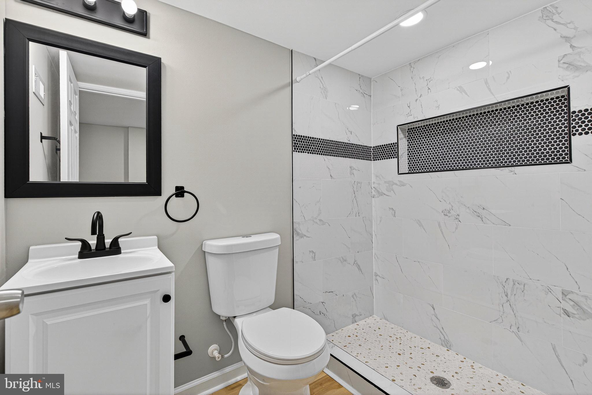 2518 West Fayette Street Baltimore, MD 21223 - Photo 22 of 32 a bathroom with a toilet sink and shower