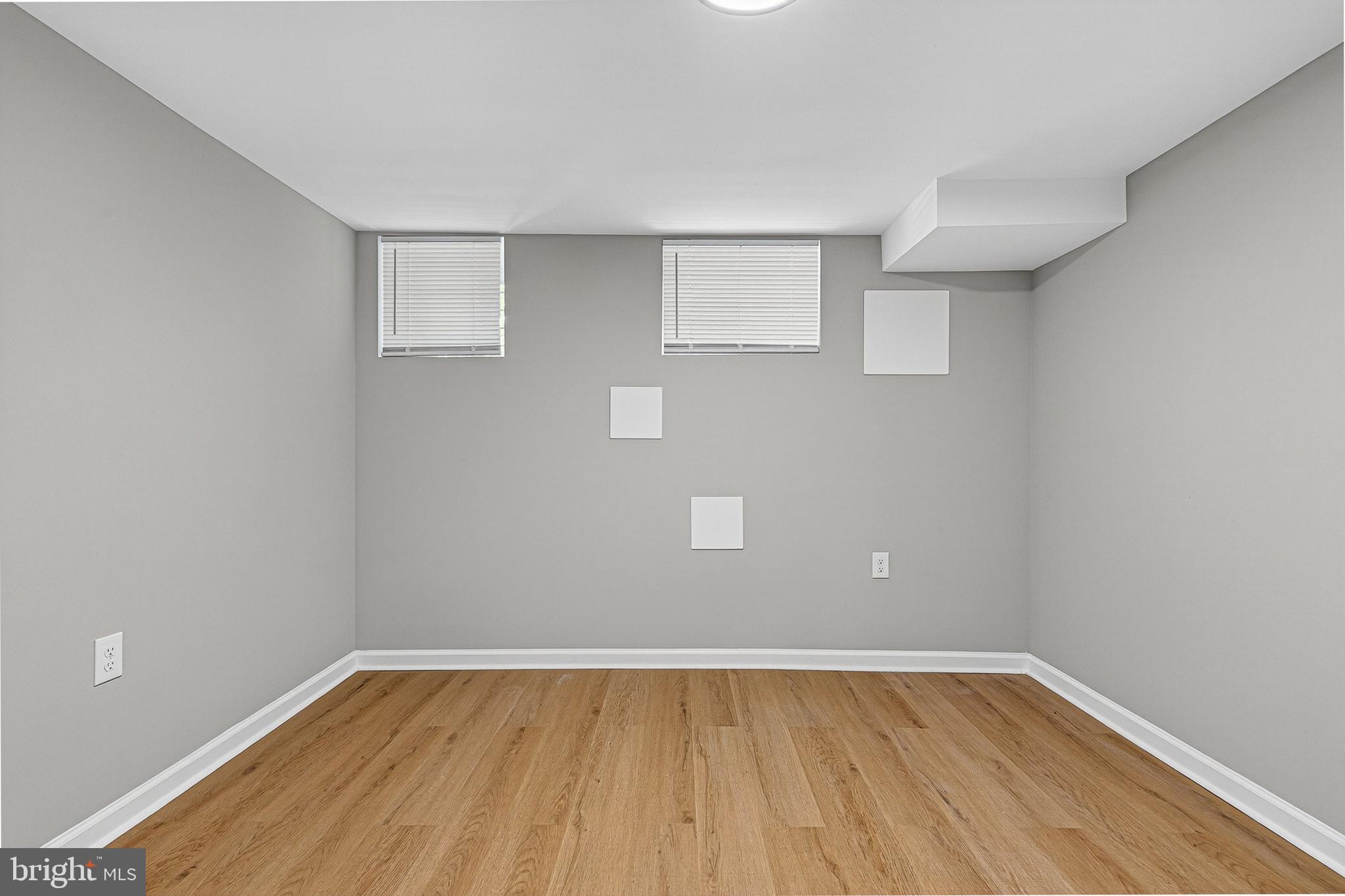 2518 West Fayette Street Baltimore, MD 21223 - Photo 24 of 32 a view of an empty room with wooden floor and a window