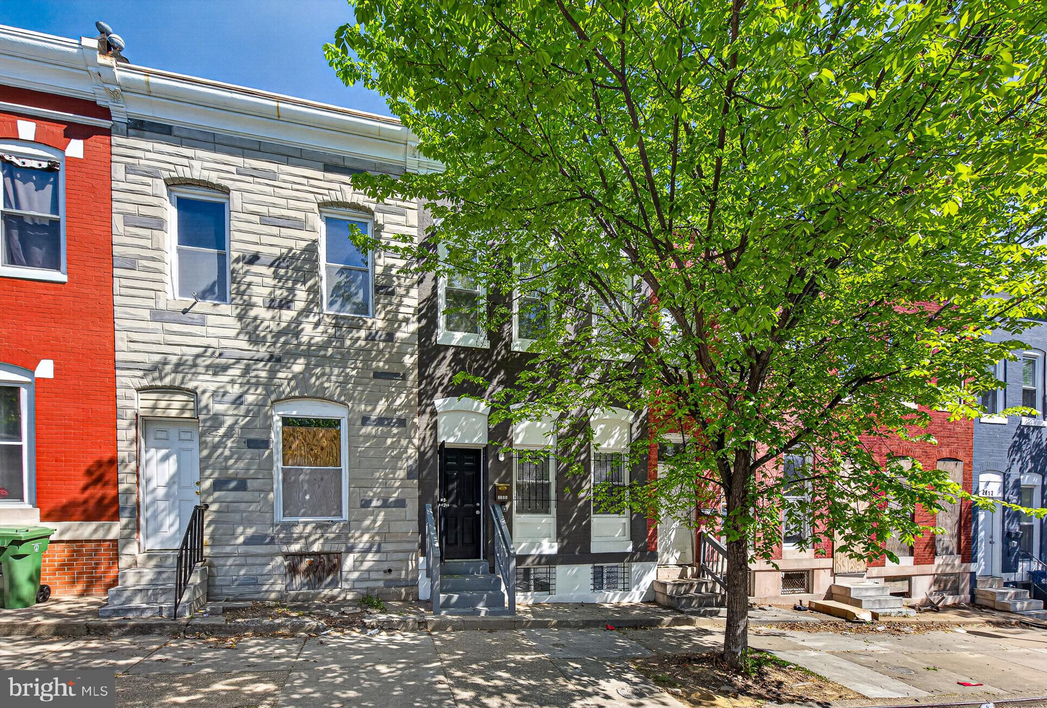 2518 West Fayette Street Baltimore, MD 21223 - Photo 31 of 32 a front view of a house with a tree