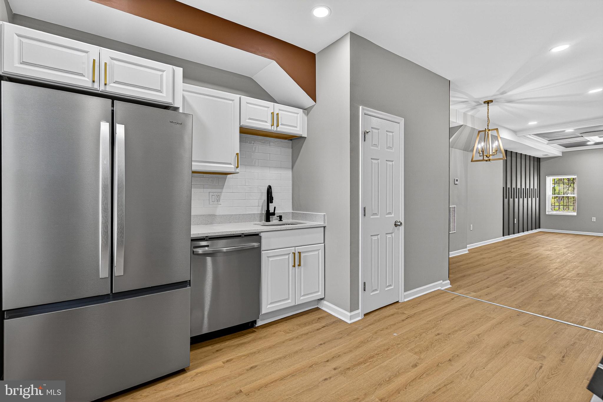 2518 West Fayette Street Baltimore, MD 21223 - Photo 4 of 32 a kitchen with stainless steel appliances a refrigerator and a stove top oven