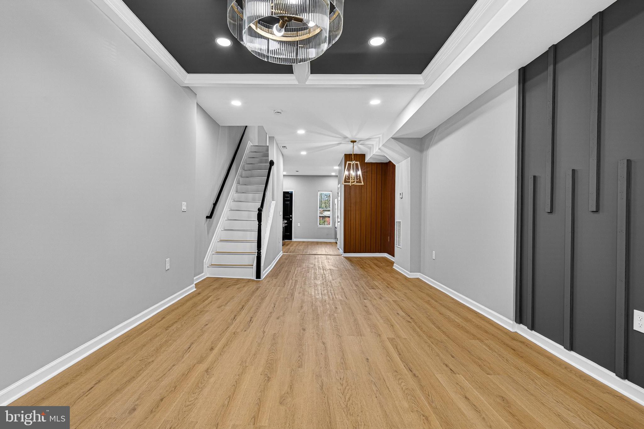 2518 West Fayette Street Baltimore, MD 21223 - Photo 5 of 32 a view of a hallway with wooden floor