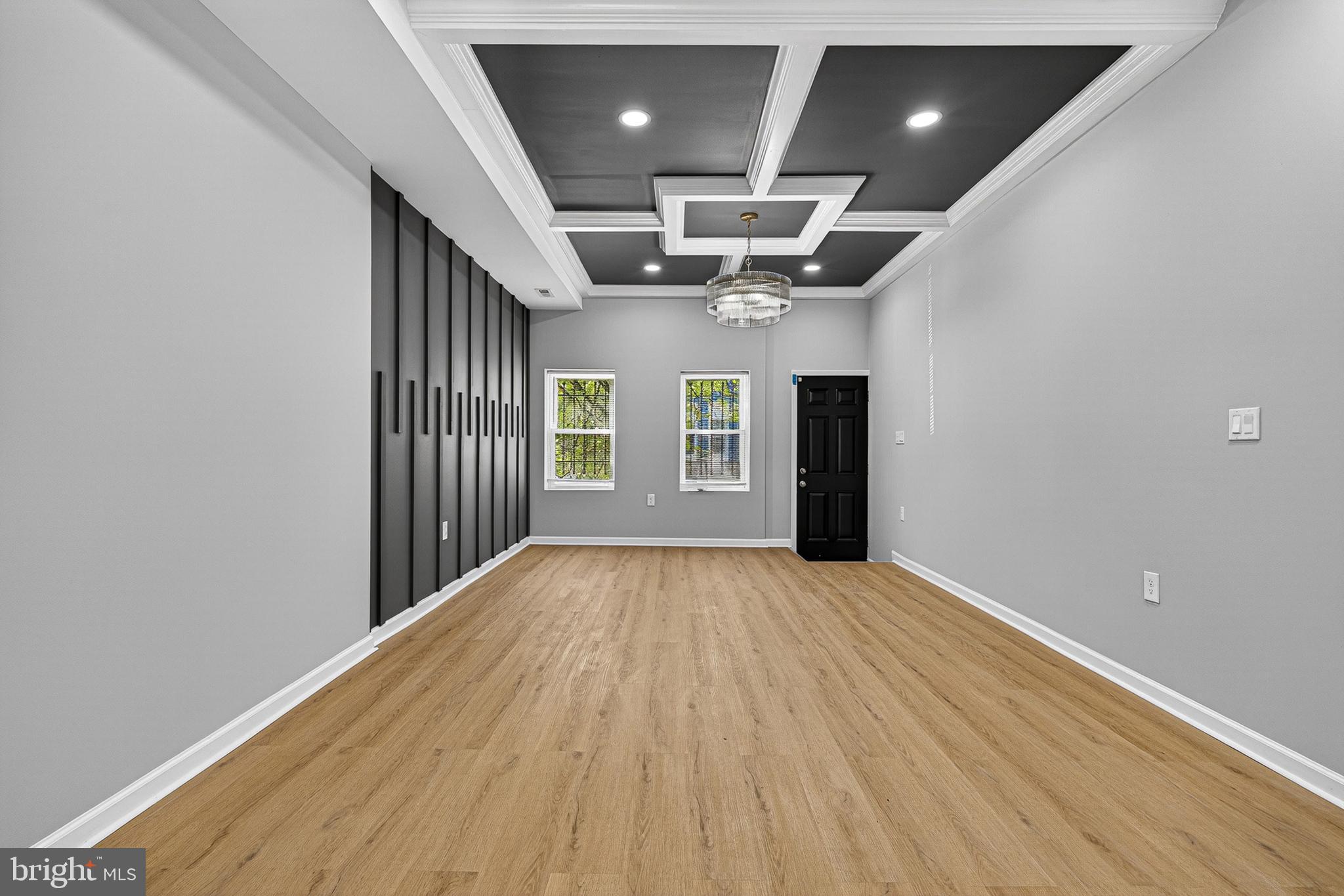 2518 West Fayette Street Baltimore, MD 21223 - Photo 7 of 32 an empty room with projector and wooden floor