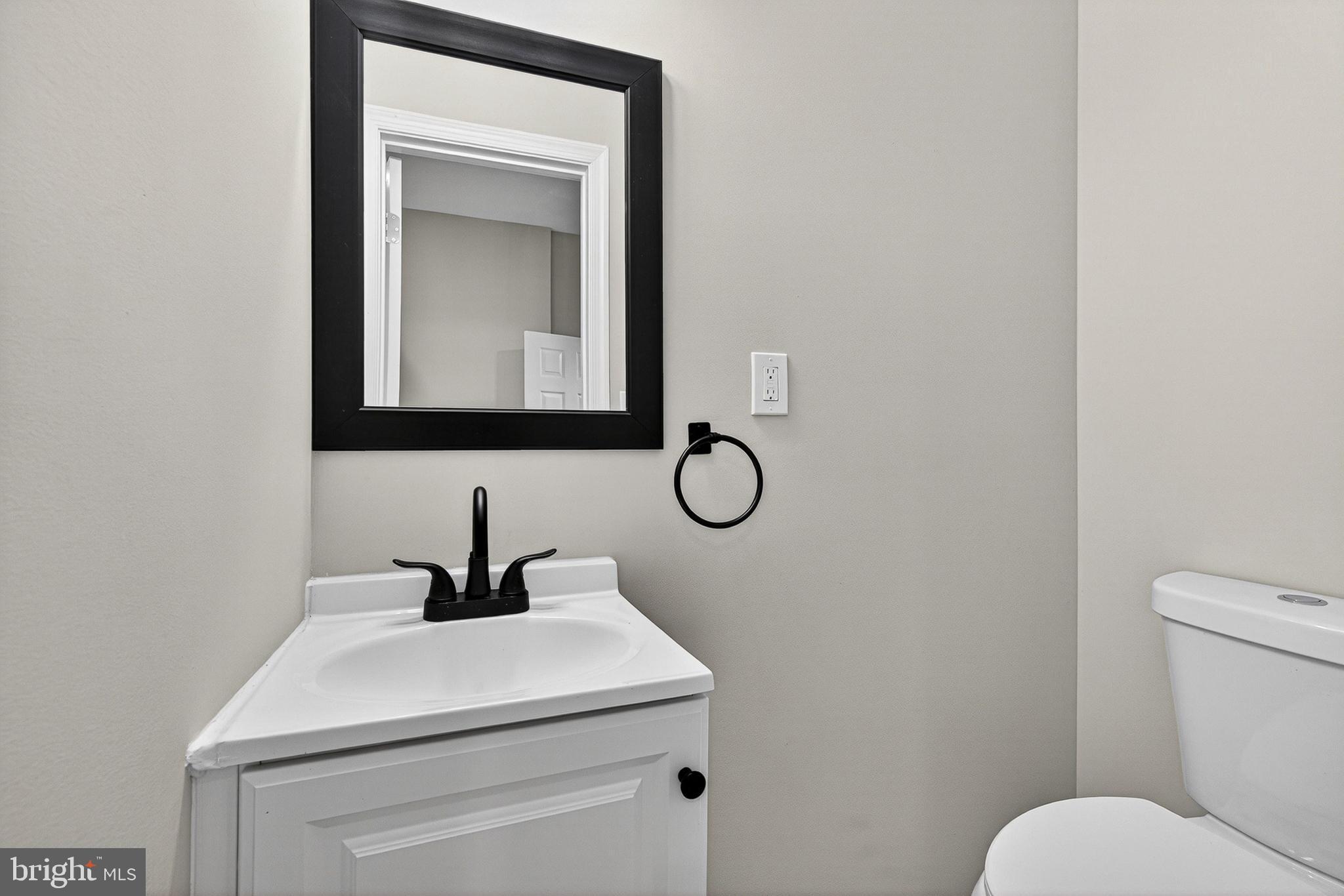 2518 West Fayette Street Baltimore, MD 21223 - Photo 9 of 32 a bathroom with a toilet sink and mirror