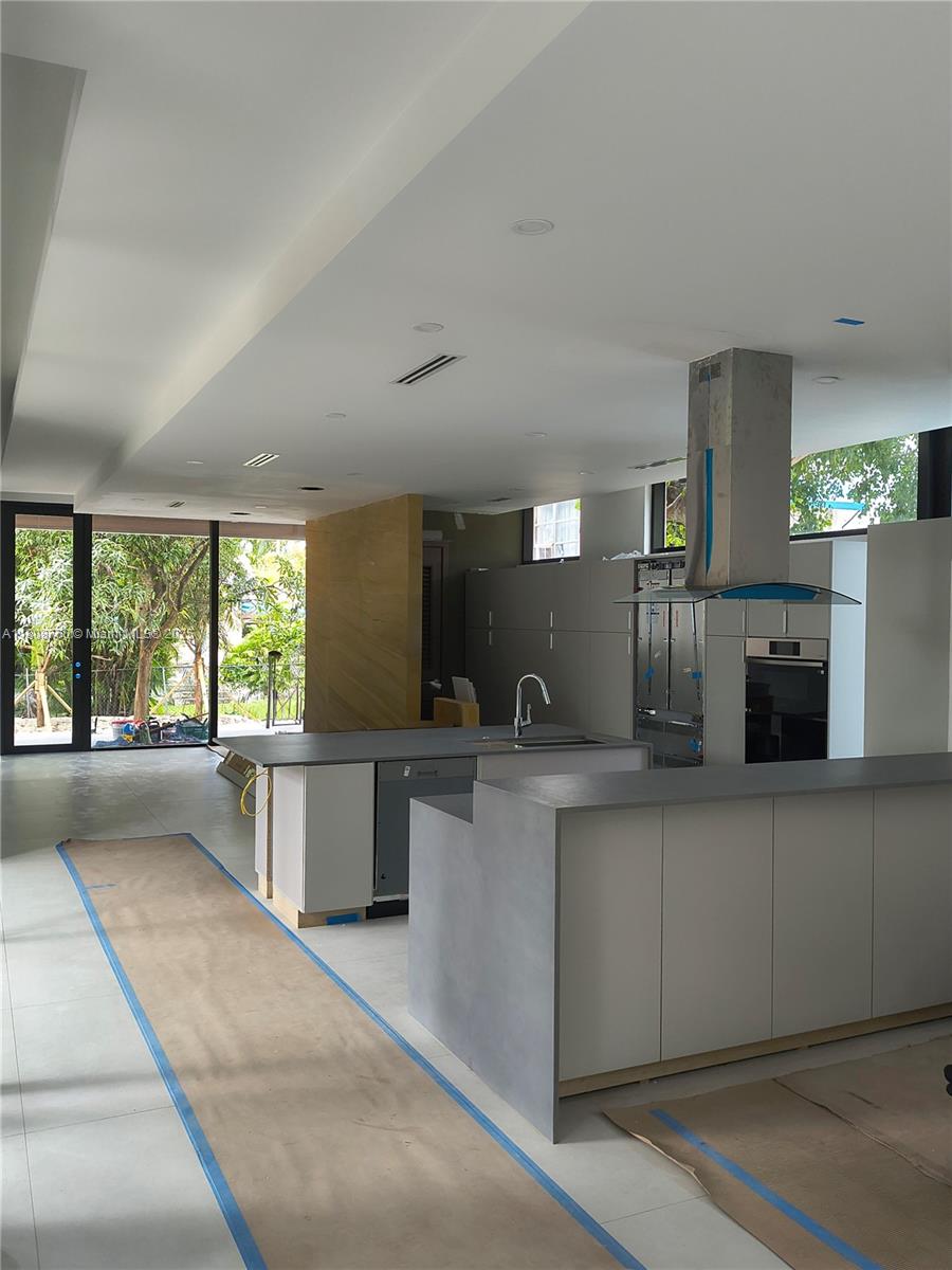 234 Southwest 22nd Road Miami, FL 33129 - Photo 12 of 31 a kitchen with stainless steel appliances a sink a stove a refrigerator and cabinets