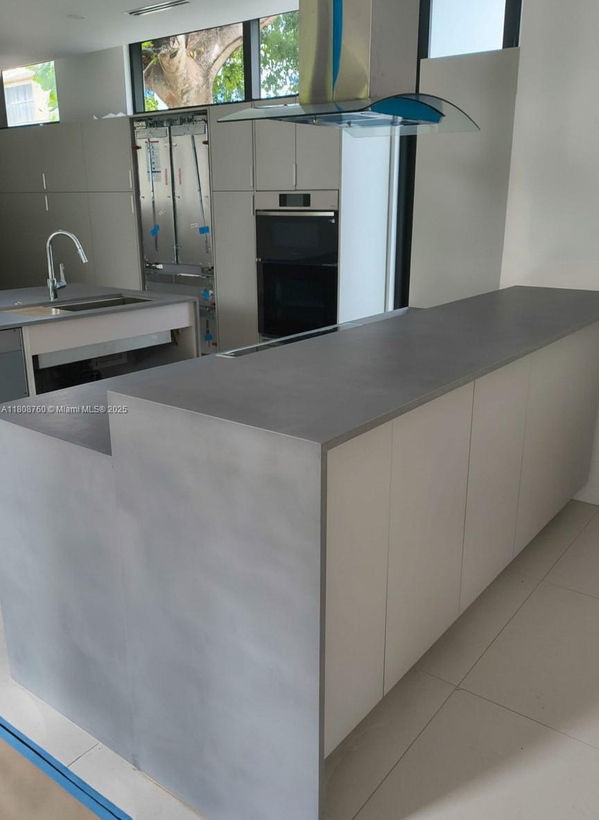 234 Southwest 22nd Road Miami, FL 33129 - Photo 13 of 31 a kitchen with stainless steel appliances a refrigerator and a sink