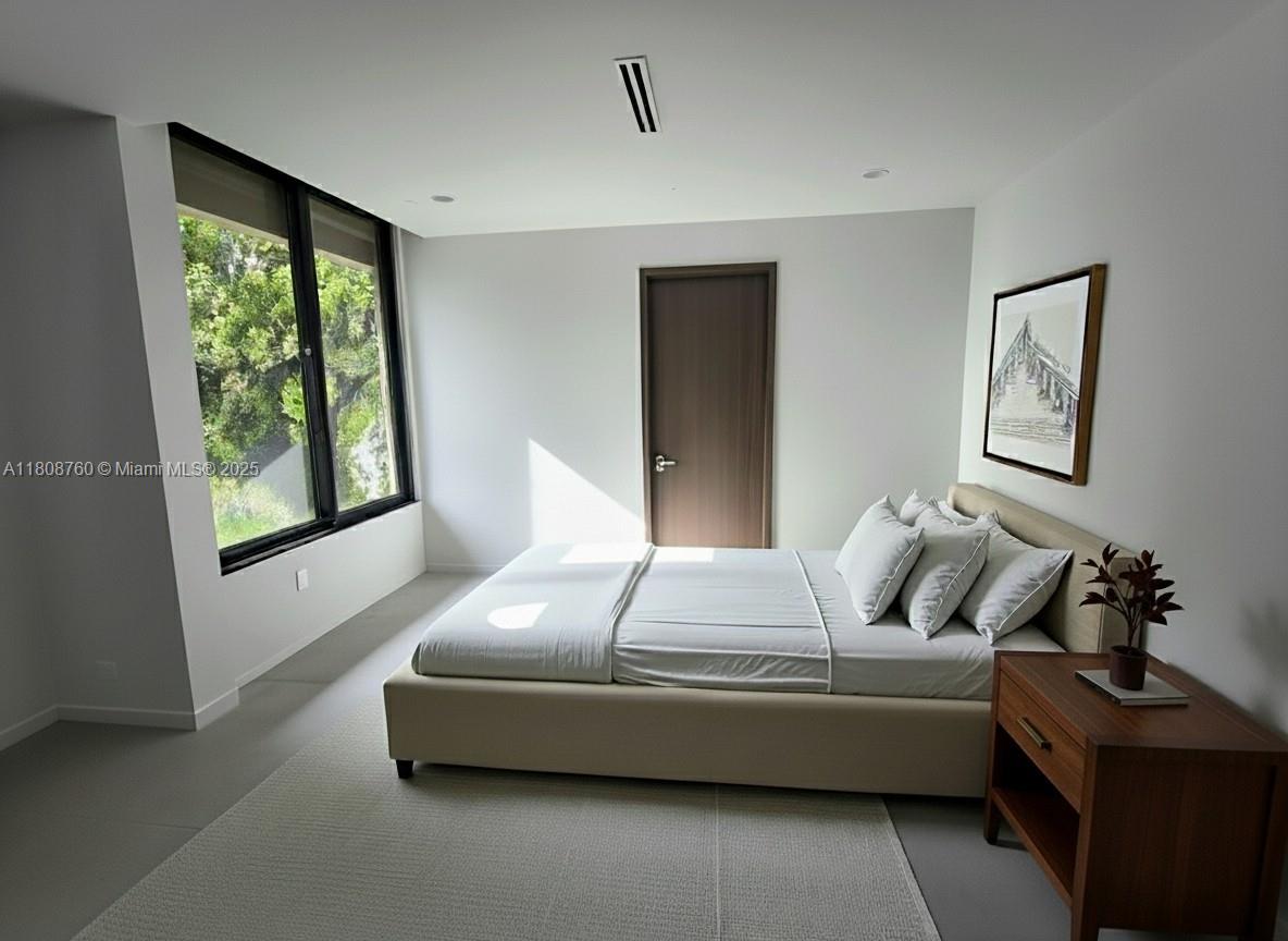 234 Southwest 22nd Road Miami, FL 33129 - Photo 19 of 31 a bedroom with furniture and a window
