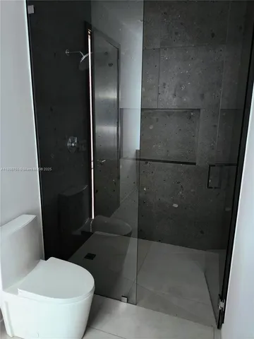 a bedroom with a bed and a mirror