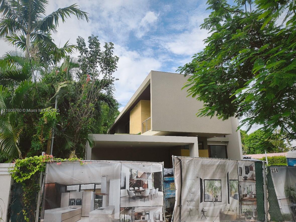 234 Southwest 22nd Road Miami, FL 33129 - Photo 2 of 31 a front view of house with yard and trees in the background