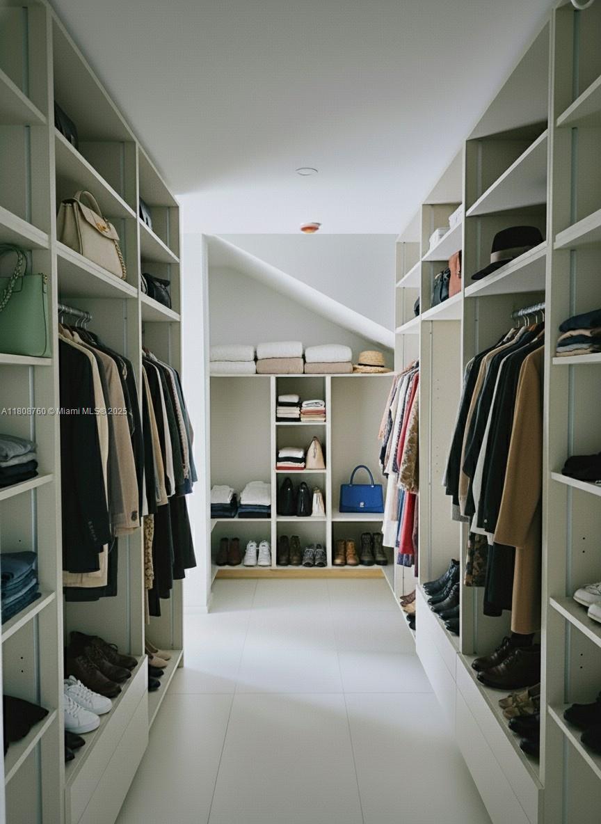234 Southwest 22nd Road Miami, FL 33129 - Photo 24 of 31 a view of walk in closet with clothes and shoes