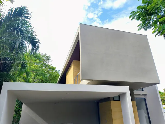 a view of a patio with table and chairs with wooden floor and fence
