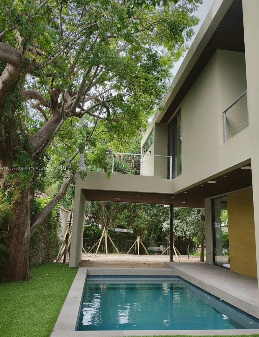 234 Southwest 22nd Road Miami, FL 33129 - Photo 8 of 31 a view of a patio with table and chairs with wooden floor and fence