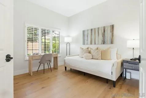 a bed room with a bed and a chair