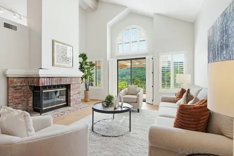 a living room with furniture large window and fireplace
