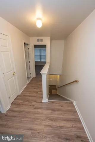 a view of hallway with wooden floor
