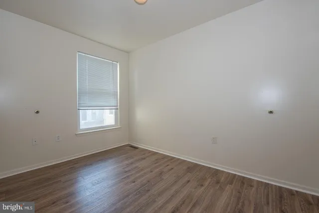 a view of hallway with wooden floor