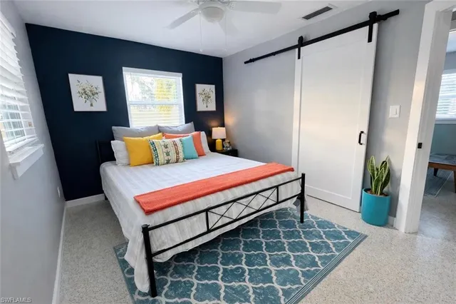 a bedroom with a bed and window