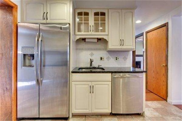 129 Russell Road Newton, MA 02465 - Photo 7 of 19 a kitchen with stainless steel appliances granite countertop a refrigerator and a stove