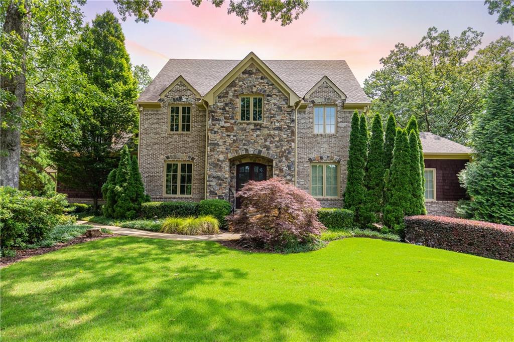 Gorgeous brick and stone exterior with mature, professional landscaping.
