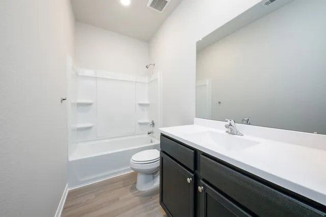 a bathroom with a sink a toilet and bathtub