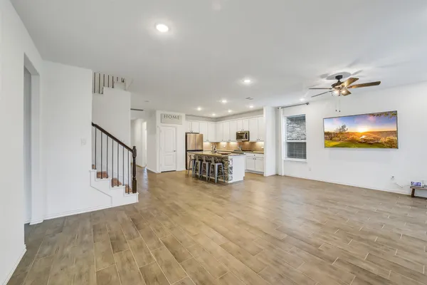 a view of a livingroom with furniture and a flat screen tv