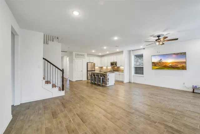 a view of a livingroom with furniture and a flat screen tv
