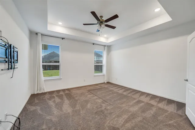 a view of a livingroom with a ceiling fan and window