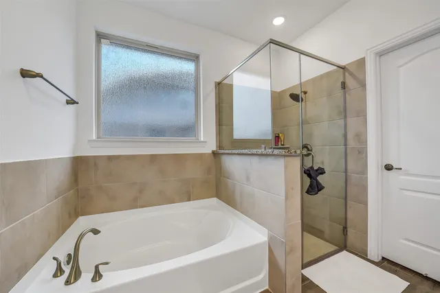 a bathroom with a tub and shower