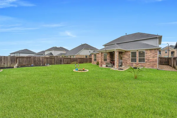 a view of a house with a backyard