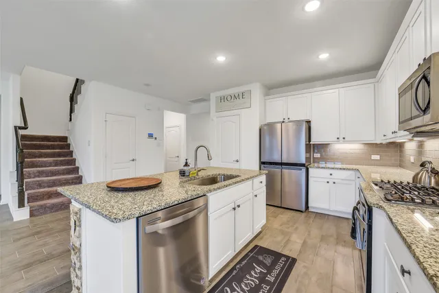 a kitchen with a sink stove and refrigerator