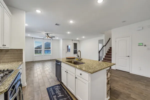 a kitchen with sink and stove