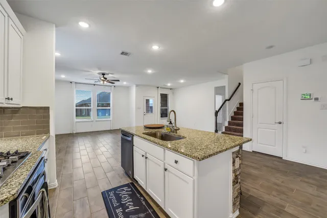 a kitchen with sink and stove