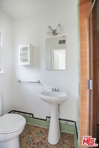a bathroom with a sink toilet and mirror