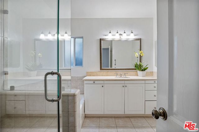 a bathroom with a sink vanity and a mirror