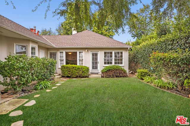 a view of a house next to a yard