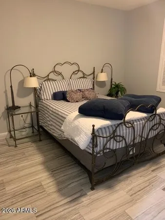 a bedroom with furniture and wooden floor