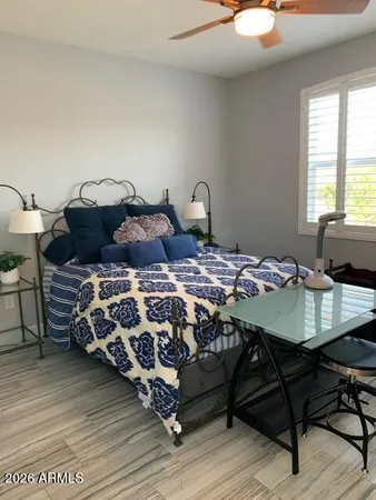 a bedroom with a bed a table and chair