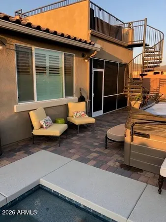 a view of a patio with couches table and chairs with wooden floor