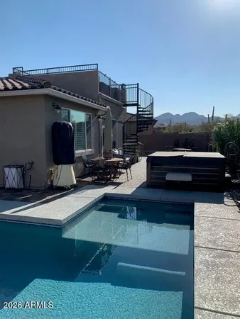 a roof deck with couches and potted plants