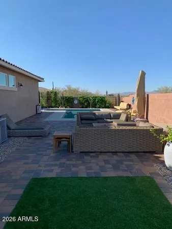a backyard of a house with table and chairs