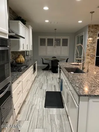 a kitchen with a sink stove and cabinets