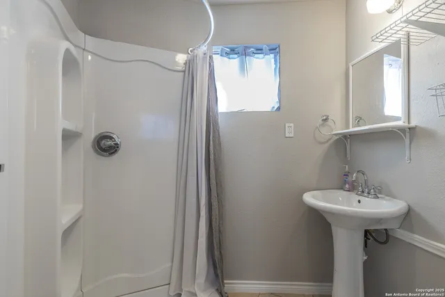 a bathroom with a sink a toilet and mirror