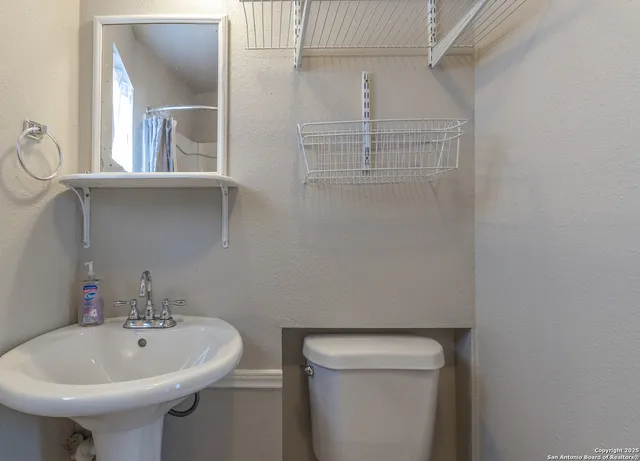 a view of a backyard with table and chairs potted plants and wooden fence