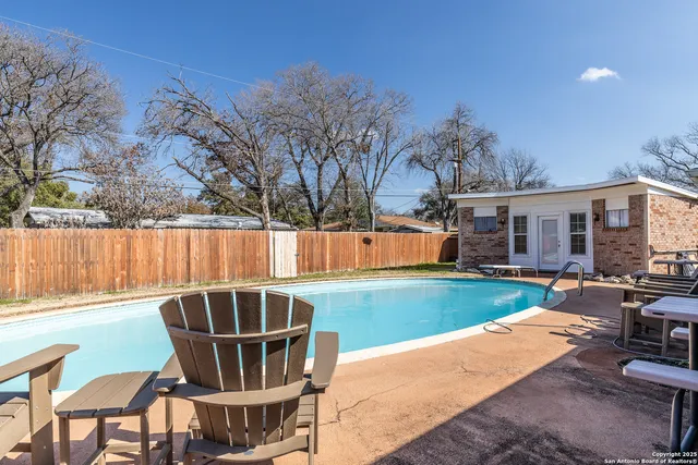 a view of a swimming pool with a patio