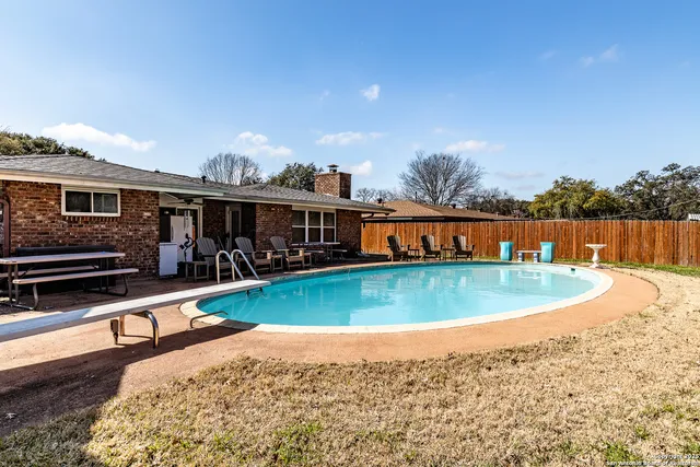 a view of a swimming pool with outdoor seating