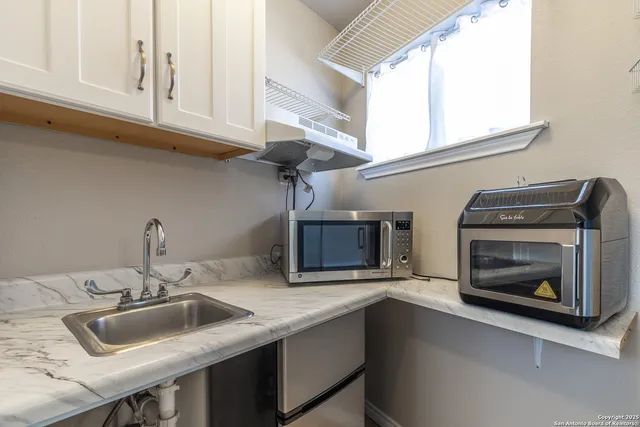 a bathroom with a sink a mirror and shower