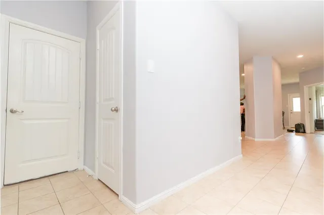 a view of a hallway with a livingroom and a bathroom