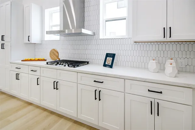 a kitchen with white cabinets and white appliances