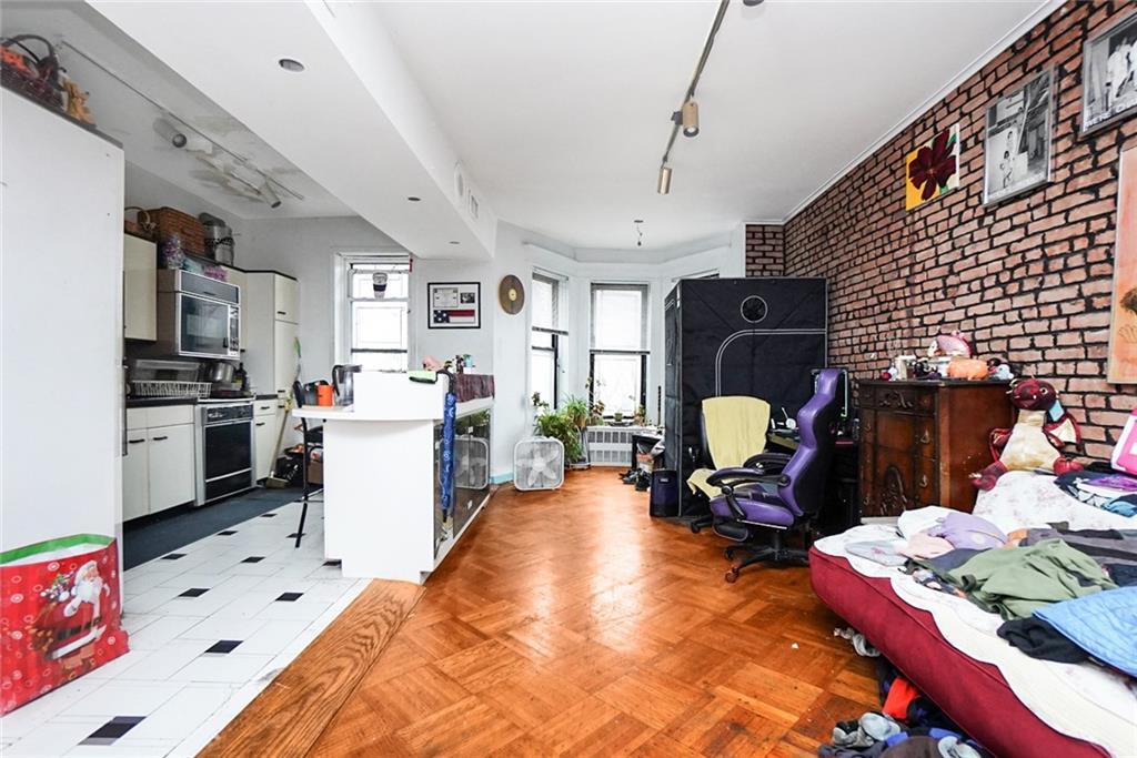 365 Bay Ridge Parkway Brooklyn, NY 11209 - Photo 24 of 33 a living room filled with furniture and a kitchen